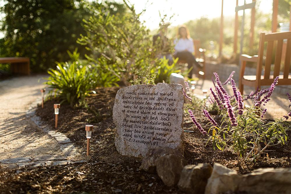 祷告花园里的一块刻有腓立比书4:3-7的经文石 